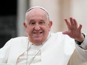 The Pope waves at St Peter's Basilica