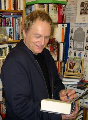 Phil signing copies of one of his books previously