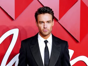 Liam Payne on the red carpet in a suit and tie