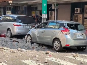 Cars in the street damaged by falling masonry