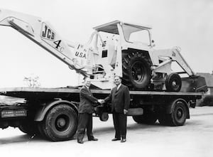 In 1964, JCB exported its first machine to the US. Mr Bamford is pictured, left  