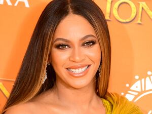 Beyonce smiles at the camera at Disney’s The Lion King European premiere in London