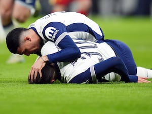 Pedro Porro checks on team-mate Rodrigo Bentancur