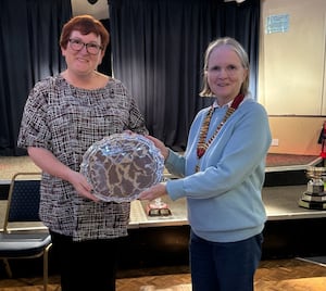 Cup that cheers – Louise Cotton accepts the County Women’s Cup from Pauline Wilson