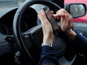 A person using a phone while driving