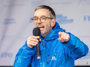 Herbert Kickl shouts into a microphone