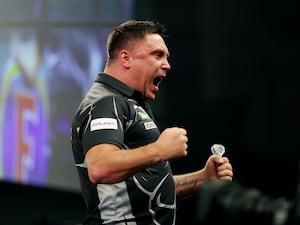 Gerwyn Price celebrates victory in the second round at the World Darts Championship in London