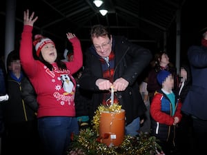 Kington Chamber of Trade Chairman Emma Hancocks cheers as post master Tim Allen pushed the plunger to switch on the Christmas lights. Image: Andy Compton