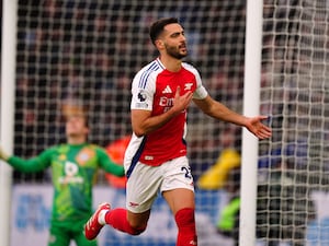 Mikel Merino puts his hand on his chest as he runs away from goal in celebration