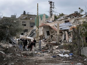 Lebanese citizens check the destruction in their village