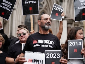 Andrew Malkinson wearing a top which says 'Innocent', surrounded by supporters