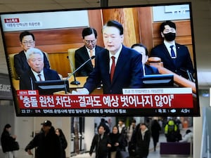 A TV screen shows footage of impeached South Korean President Yoon Suk Yeol’s address