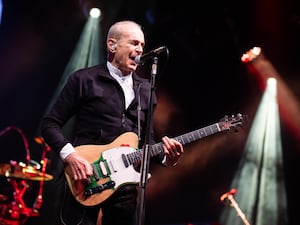 Status Quo’s Francis Rossi performing on stage