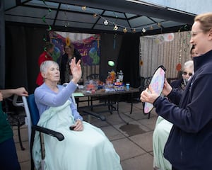 Patients taking part in activities at the opening of the courtyard.