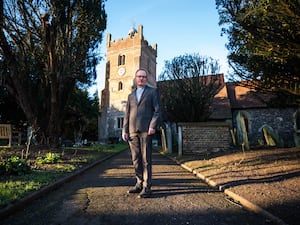 The Revd Richard Young poses outside St Mary the Virgin Church