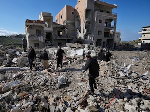 Residents check their destroyed houses after they returned to Qana village, southern Lebanon