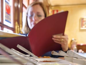 A person reading a menu in a restaurant