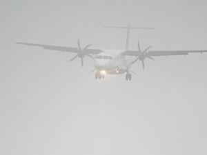 View of a plane through a misty sky