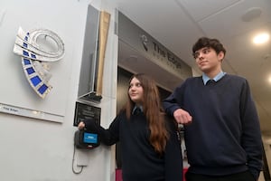 An Olympic torch in reception and pupils: Mary-Jane Carter 14 and Jack Doody 13.