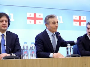 Georgian Prime Minister Irakli Kobakhidze, left, Bidzina Ivanishvili, leader of the created Georgian Dream party which he initiated, and Mikheil Kavelashvili, who was nominated by the governing Georgian Dream party as a candidate for the presidential election, speak to the media, in Tbilisi, Georgia