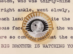 The new George Orwell coin over some text