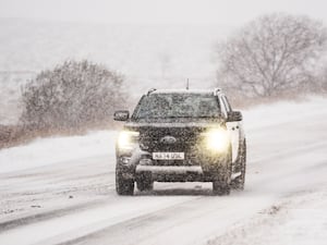 A car driving in snowy weather