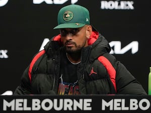 Nick Kyrgios answers questions at a press conference at Melbourne Park