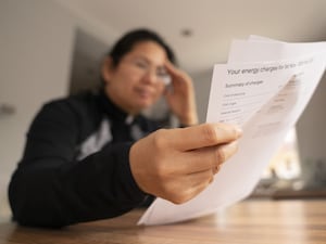 A woman looking at an energy bill