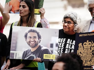 People holding a picture of Alaa Abd el-Fattah during a protest