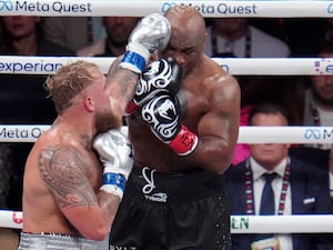 Jake Paul (left) lands a left to Mike Tyson during their boxing match