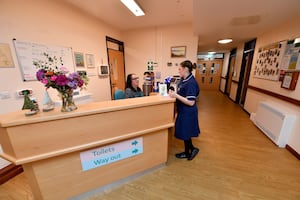 Ward Sister Charlotte Skelly talking to receptionist Alison Austin.