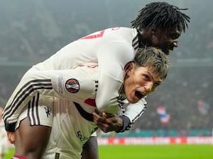 Manchester United’s Kobbie Mainoo, top, celebrates his goal against FCSB with Alejandro Garnacho who provided the assist