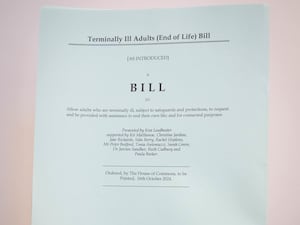 A person holds a hard copy of the Terminally Ill Adults (End of Life) Bill proposed by Labour MP Kim Leadbeater