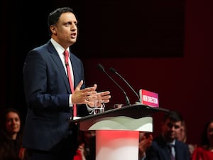 Anas Sarwar delivering a speech at a Labour lectern