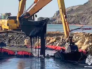 An excavator works removing oil near the damaged Volgoneft-239 tanker