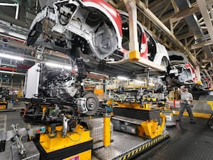 Workers on a vehicle production line