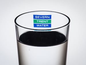 The logo of water company Severn Trent Water seen through a glass of water