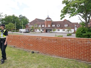 Police officers outside Potters International Hotel in Aldershot during the protest