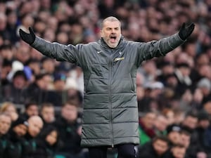 Ange Postecoglou shouts on the touchline with his arms spread wide