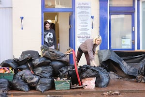 People cleaning up after the flooding in Tenbury Wells. Photo: Anita Maric/SWNS