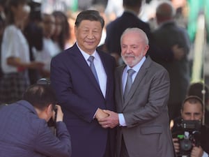 China’s President Xi Jinping and Brazil’s President Luiz Inacio Lula da Silva shaking hands