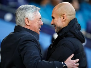 Real Madrid manager Carlo Ancelotti, left, embraces Manchester City manager Pep Guardiola