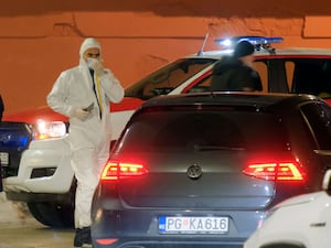 Police investigators work at the site of the shooting in Cetinje