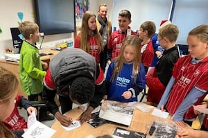 Children wearing shirts donated through the Kitmas campaign 