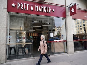 A person walks past a Pret a Manger shop