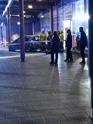 Emergency servies could seen working at the scene of a crash where a car collided with a Tesco building