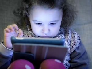 A child uses a tablet computer