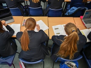 Schoolgirls doing schoolwork at desks