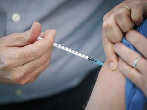 A person receiving a vaccination injection