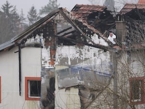 Police officers inspect a home for the elderly